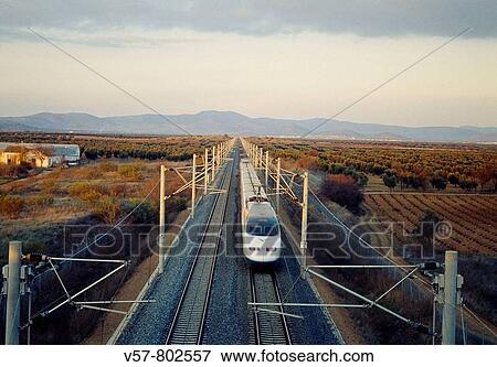 AVE High-speed train Madrid-Sevilla traveling along La Mancha. Ciudad Real province, Castilla La Mancha, Spain. View Large Photo Image Stock Photo - AVE High-speed train Madrid-Sevilla traveling along La Mancha. Ciudad Real province, Castilla La Mancha, Spain.. Fotosearch