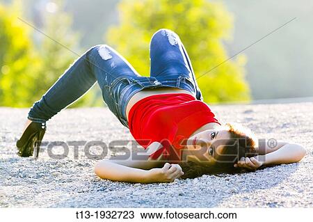 Awkward lying on ground young woman View Large Photo Image Stock Image - Awkward lying on ground young woman. Fotosearch