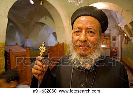 ? Baba? (father) Tawdros priest of Theodoros El-Morhab coptic church and monastery on first sunday after Easter. West bank of river Nile. Luxor. Egypt View Large Photo Image Stock Image - ? Baba? (father) Tawdros priest of Theodoros El-Morhab coptic church and monastery on first sunday after Easter. West bank of river Nile. Luxor. Egypt. Fotosearch
