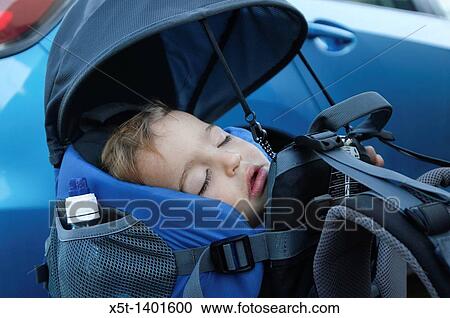 Baby asleep in a backpack baby carrier View Large Photo Image Stock Image - Baby asleep in a backpack baby carrier. Fotosearch