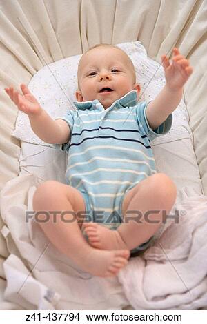 Picture - Baby awakening in cradle. Fotosearch