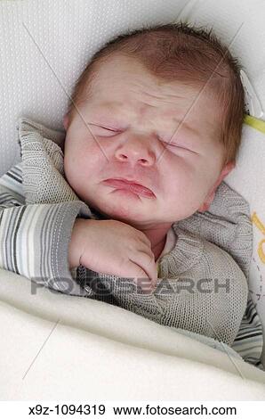 Baby boy 3 weeks old doing a sade face during his sleep nightmare View Large Photo Image Stock Photo - Baby boy 3 weeks old doing a sade face during his sleep nightmare. Fotosearch