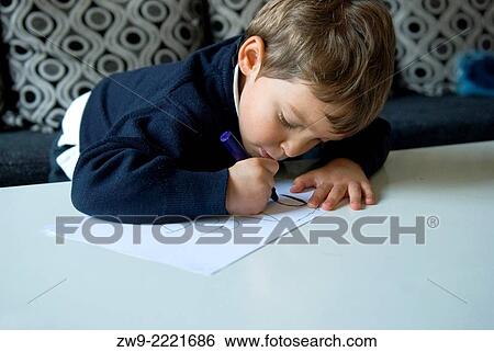 Stock Photograph - Baby boy drawing, Madrid.. Fotosearch