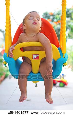 Stock Photo - Baby boy fast asleep on a swing. Fotosearch