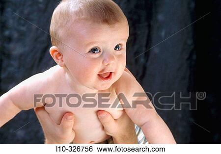 Baby boy flying in the air, actually help up by his daddy View Large Photo Image Stock Photograph - Baby boy flying in the air, actually help up by his daddy. Fotosearch
