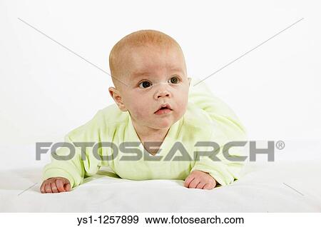 BABY BOY IN PYJAMAS AGAINST WHITE BACKGROUND View Large Photo Image Stock Photo - BABY BOY IN PYJAMAS AGAINST WHITE BACKGROUND. Fotosearch