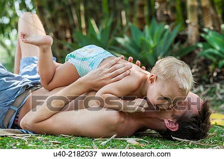 Stock Photo - baby boy playing with his father.. Fotosearch