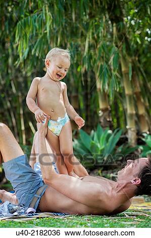 baby boy playing with his father. View Large Photo Image Stock Photograph - baby boy playing with his father.. Fotosearch