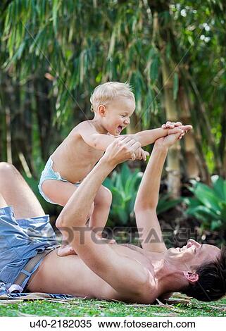 Stock Photography - baby boy playing with his father.. Fotosearch