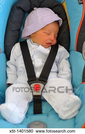 Baby boy sleeping strapped into a car seat View Large Photo Image Stock Image - Baby boy sleeping strapped into a car seat. Fotosearch