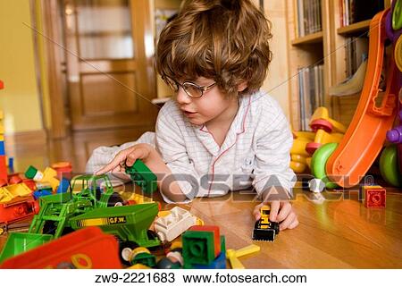 Baby boy three years old playing on the floor with plastic cars and blocks, Madrid, Spain View Large Photo Image Stock Image - Baby boy three years old playing on the floor with plastic cars and blocks, Madrid, Spain. Fotosearch