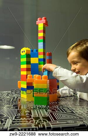 Stock Photo - Baby boy three years old playing whit blocks and making a colored tower, Madrid, Spain. Fotosearch