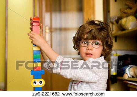 Baby boy three years old with glasses playing with plastic blocks, Madrid, Spain View Large Photo Image Stock Image - Baby boy three years old with glasses playing with plastic blocks, Madrid, Spain. Fotosearch