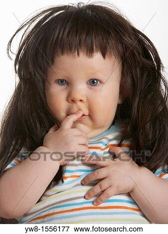 Stock Photo - Baby boy wearing wig. Fotosearch