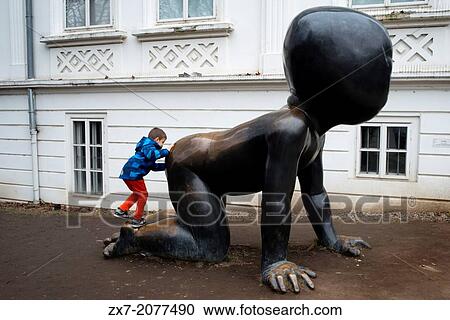 Stock Image - Baby crawling giant Kampa Island. Prague.. Fotosearch