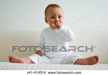 Baby eating a rice-cracker View Large Photo Image Picture - Baby eating a rice-cracker. Fotosearch