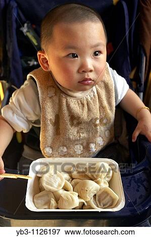 Baby Eating Dumplings, Shanghai, China View Large Photo Image Stock Photo - Baby Eating Dumplings, Shanghai, China. Fotosearch