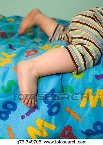 Baby feet on an alphabet blanket View Large Photo Image Stock Photograph - Baby feet on an alphabet blanket. Fotosearch