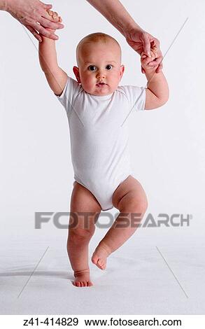 Baby first steps View Large Photo Image Stock Photo - Baby first steps. Fotosearch