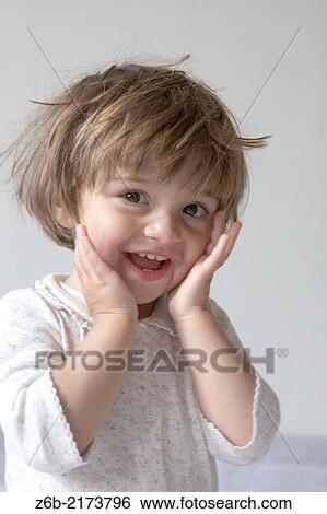 Stock Photograph - Baby Girl, 21 months, Toddler, cheerful, expressive, gesture, hands, adorable, pyjamas. Fotosearch