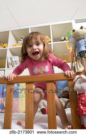 Baby girl, 27 months, Toddler, cot, shouting, toys, stuffed toy, bedroom, bodysuit, leaning View Large Photo Image Stock Image - Baby girl, 27 months, Toddler, cot, shouting, toys, stuffed toy, bedroom, bodysuit, leaning. Fotosearch