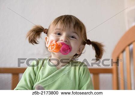 Baby girl, 27 months, Toddler, dummy, pacifier, Ponnytails, bedroom, cot, smiling View Large Photo Image Stock Image - Baby girl, 27 months, Toddler, dummy, pacifier, Ponnytails, bedroom, cot, smiling. Fotosearch