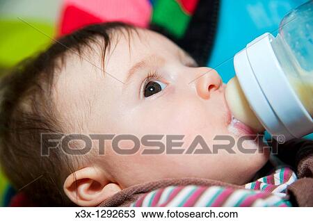 Baby girl bottle feeding View Large Photo Image Stock Image - Baby girl bottle feeding. Fotosearch