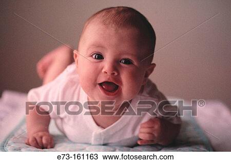 Stock Image - Baby girl laying on a blanket. Fotosearch