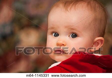 Stock Image - Baby girl looking back. Fotosearch