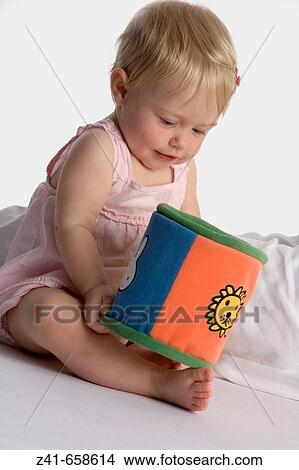 Baby girl playing with a toy View Large Photo Image Picture - Baby girl playing with a toy. Fotosearch