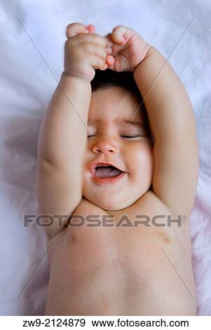 Baby girl six month old smiling and playing in a bed, Madrid, Spain View Large Photo Image Stock Photo - Baby girl six month old smiling and playing in a bed, Madrid, Spain. Fotosearch