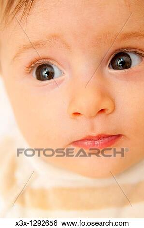 Baby girl timid face portrait View Large Photo Image Stock Photograph - Baby girl timid face portrait. Fotosearch