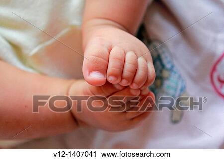 Stock Image - Baby girl's feet. Fotosearch