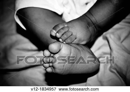 Stock Photo - Baby girl's feet. Fotosearch
