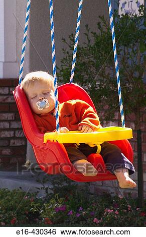 baby hanging in swing asleep View Large Photo Image Stock Photograph - baby hanging in swing asleep. Fotosearch