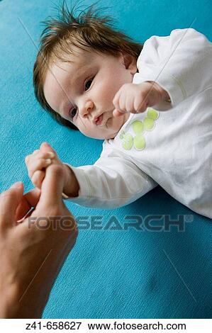 Baby holding his mothers finger View Large Photo Image Stock Photo - Baby holding his mothers finger. Fotosearch