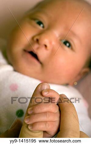 Stock Photography - Baby holding mother's hand - Lake San Pablo, near Otavalo, Ecuador. Fotosearch