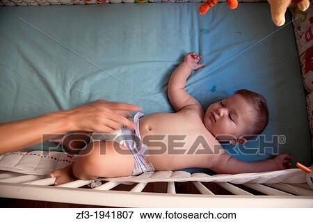 Baby in a cot View Large Photo Image Stock Photo - Baby in a cot. Fotosearch
