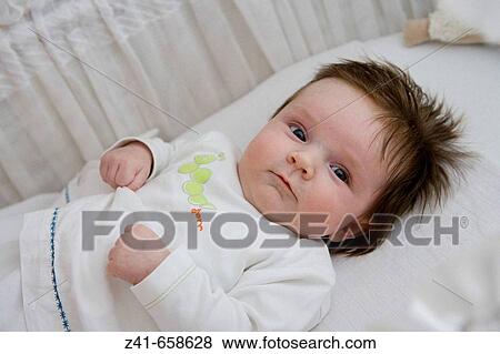 Baby in bed View Large Photo Image Stock Photo - Baby in bed. Fotosearch
