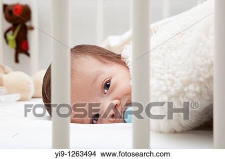 Baby in cot View Large Photo Image Picture - Baby in cot. Fotosearch