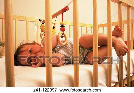 Baby in craddle View Large Photo Image Stock Photo - Baby in craddle. Fotosearch