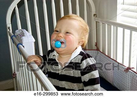 Stock Image - baby in crib. Fotosearch