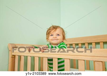 Stock Photo - Baby in his crib.. Fotosearch