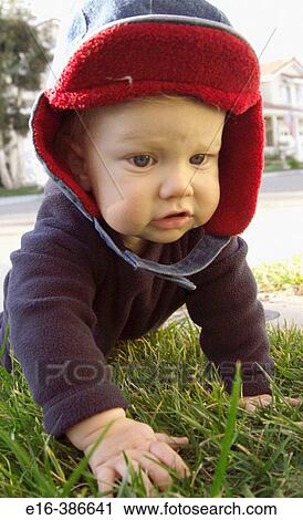 baby in jacket crawling on grass View Large Photo Image Stock Image - baby in jacket crawling on grass. Fotosearch