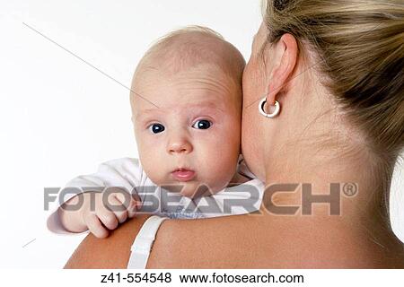 Baby looking over mothers shoulder. View Large Photo Image Stock Photo - Baby looking over mothers shoulder.. Fotosearch
