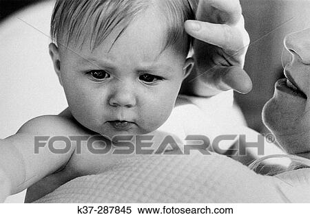 Stock Photography - Baby looking over mother's shoulder. Fotosearch