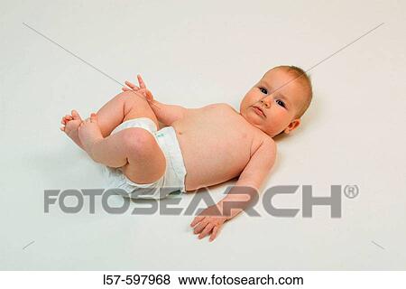 Baby lying on back, studio, Oetwil am See, Zuerich, Switzerland View Large Photo Image Stock Photo - Baby lying on back, studio, Oetwil am See, Zuerich, Switzerland. Fotosearch