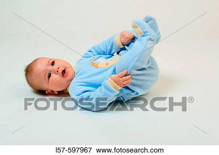 Baby lying on back, talking, wearing pyjama, wearing sleeper, studio, Oetwil am See, Zuerich, Switzerland View Large Photo Image Stock Photo - Baby lying on back, talking, wearing pyjama, wearing sleeper, studio, Oetwil am See, Zuerich, Switzerland. Fotosearch