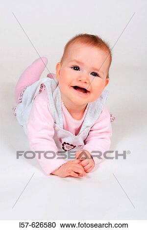 Baby lying on tummy, smiling View Large Photo Image Stock Image - Baby lying on tummy, smiling. Fotosearch