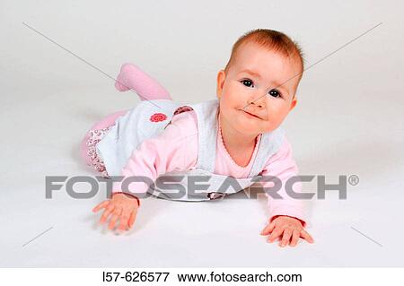 Baby lying on tummy, smiling View Large Photo Image Stock Photo - Baby lying on tummy, smiling. Fotosearch